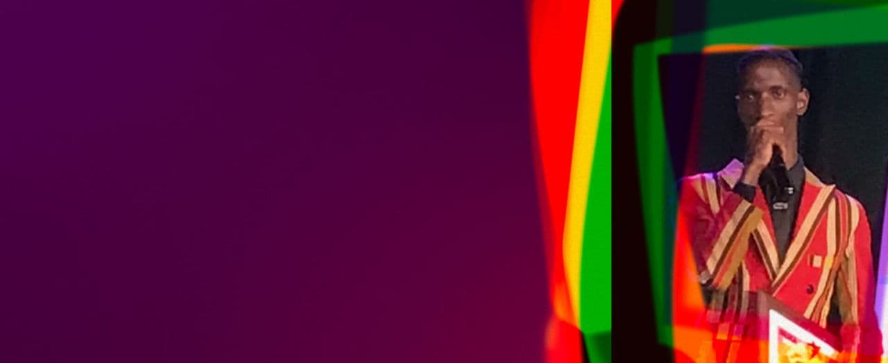 Banner featuring a speaker in a striped suit, standing against a deep purple background with colorful overlays.