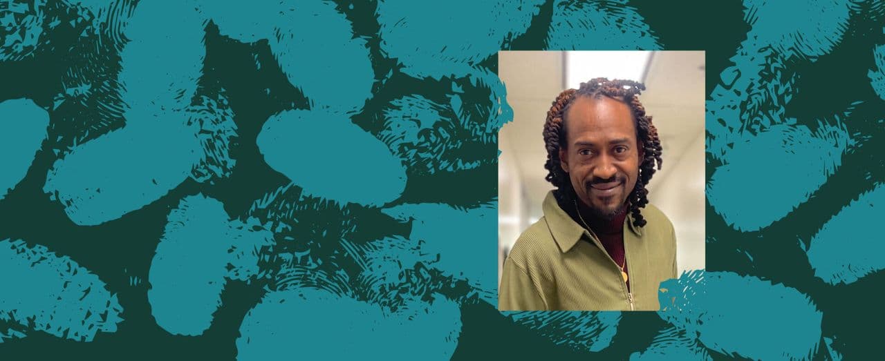 Portrait of a person smiling against a teal textured background.