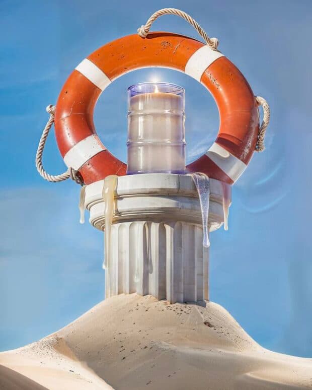 Candle on a column wrapped in a life preserver, melting in the sun.