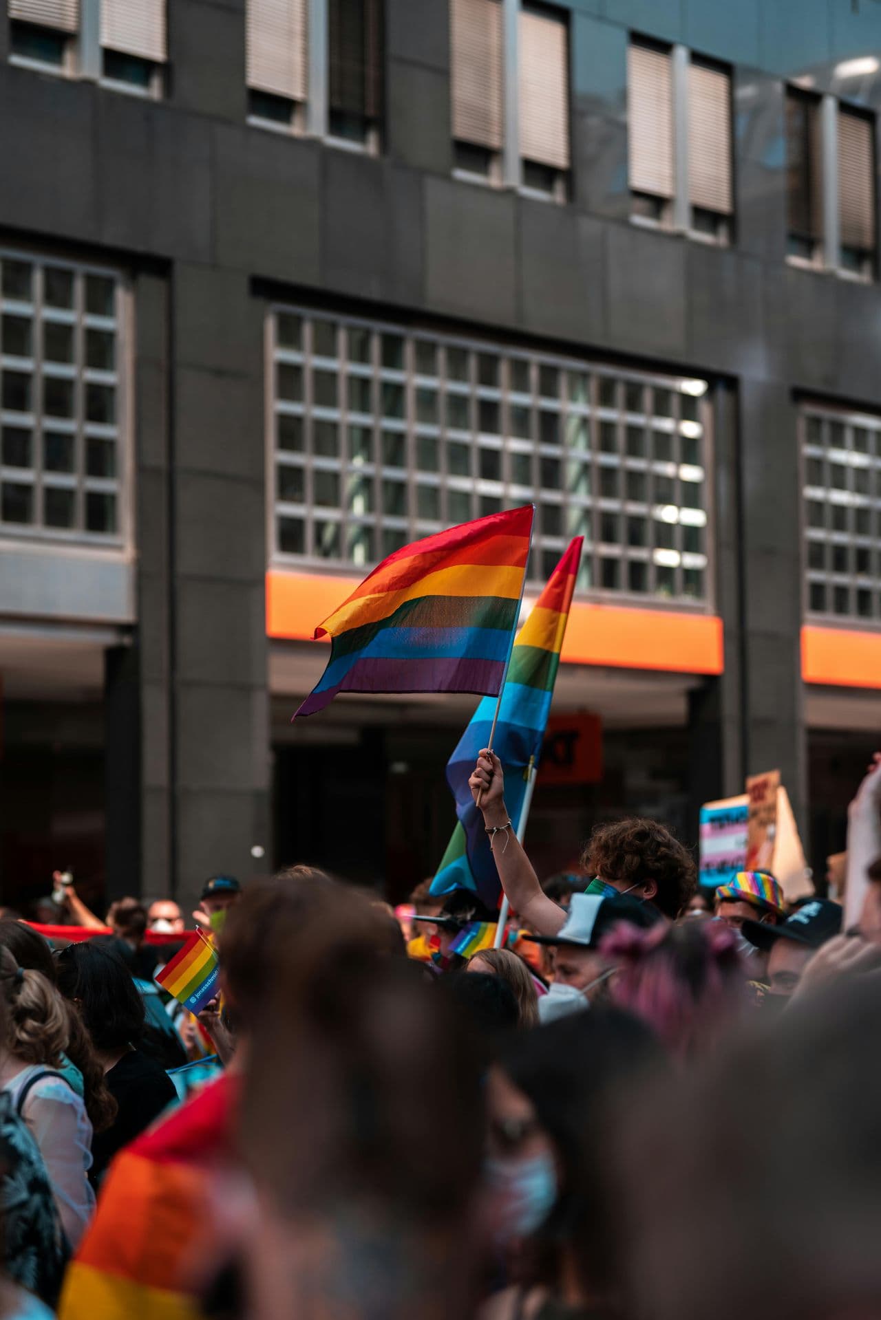 Protest crowd in city street with prominent flag