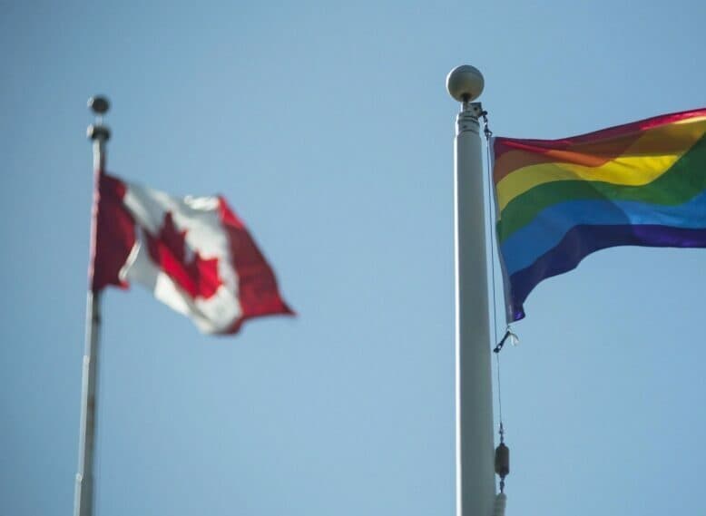 Canadian flag and rainbow flag