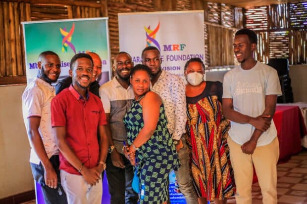 Group of people smiling in front of the MRF Banner.