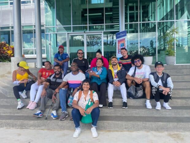 A group of people sitting together on outdoor steps.