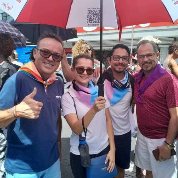 Four people standing together at an outdoor event.